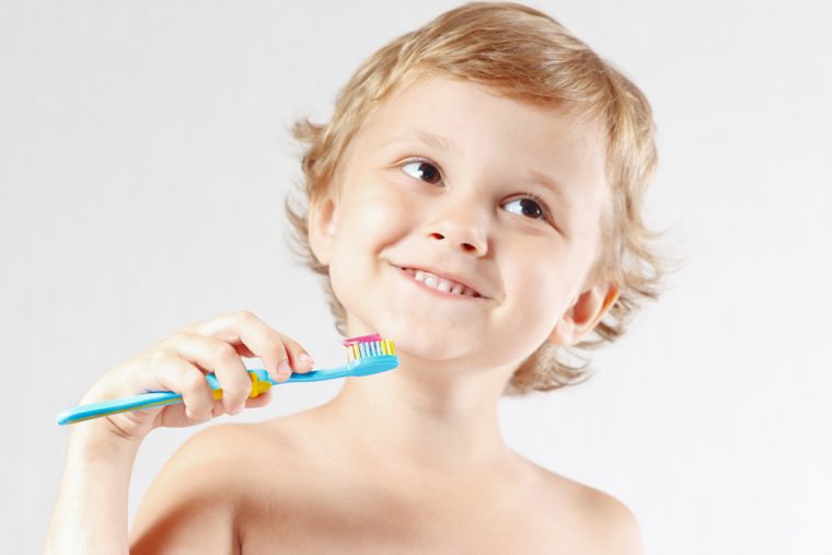 brushing teeth with fluoride toothpaste