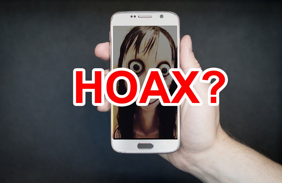 Man holding Samsung phone and written hoax 
