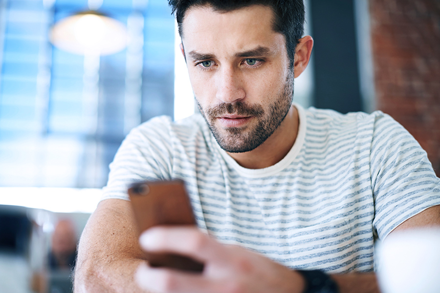 Man looking down at his smartphone