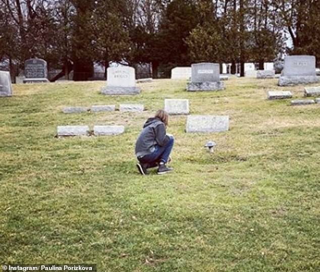 Tribute: Previously, she posted a photo of her youngest son, Oliver, crouching down at her late husband's grave