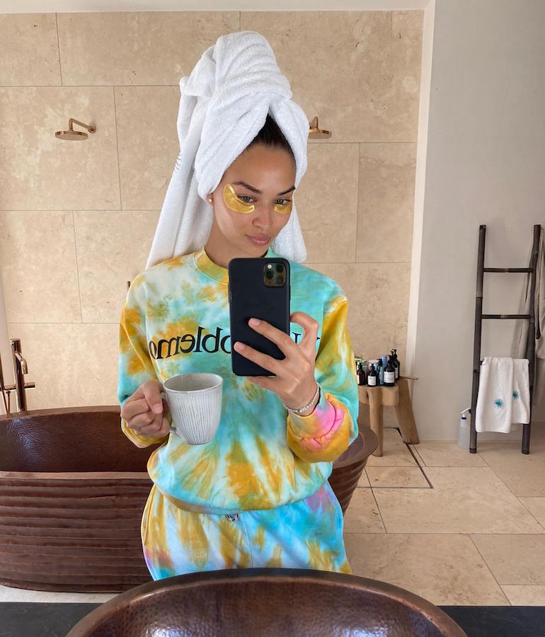 Shanina Shaik in tie-dye sweats and gold eye masks in her bathroom