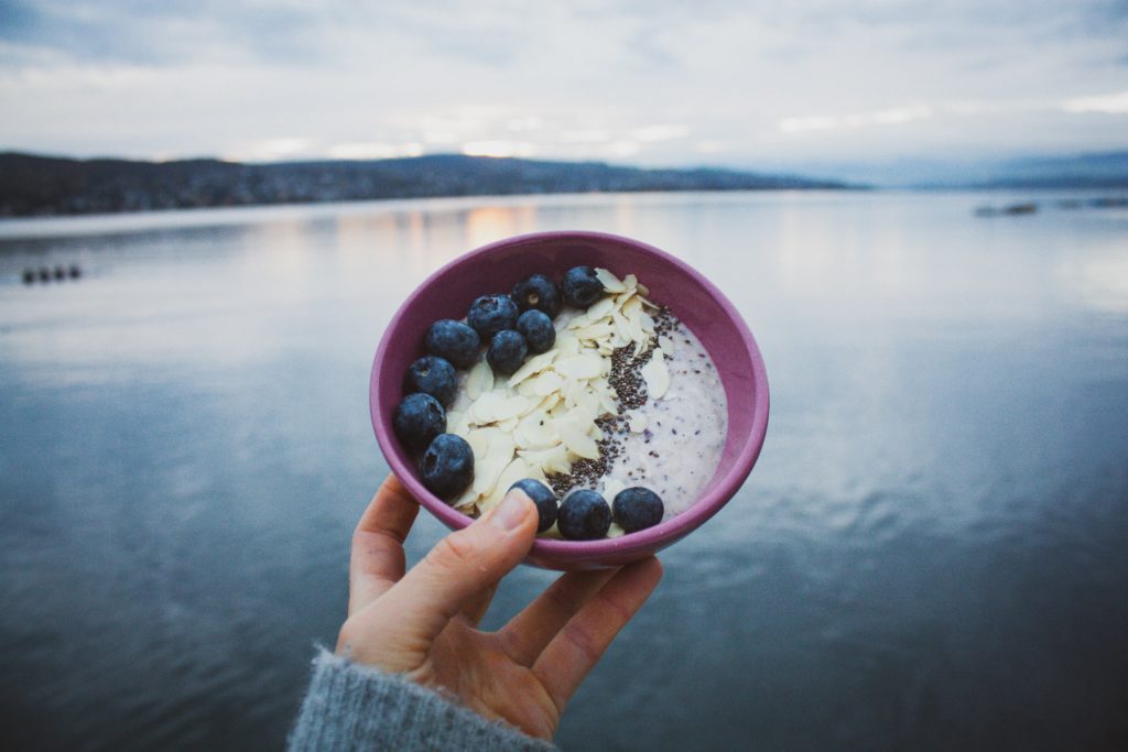 blueberries almond and yogurt in pink bowl