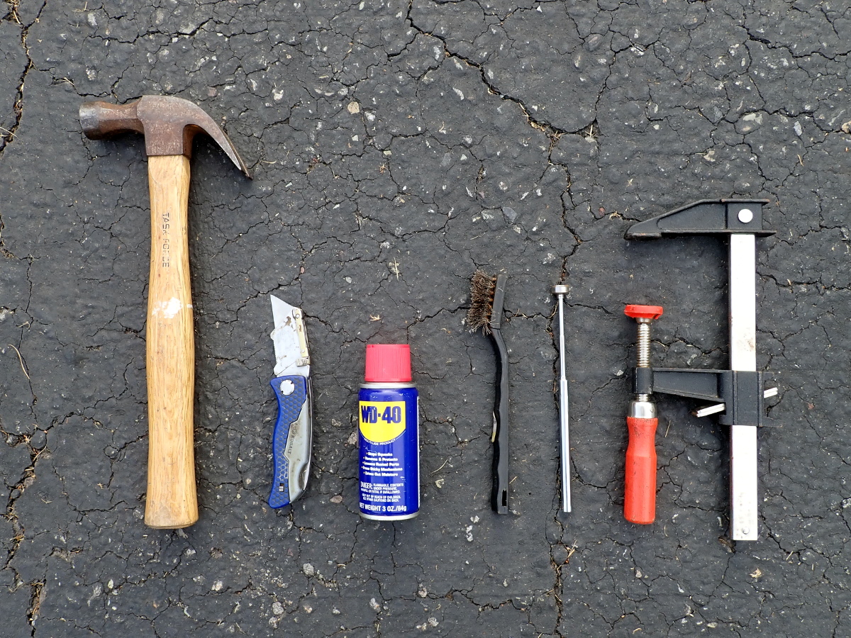 Hammer, utility knife, WD-40, wire brush, telescoping magnet, bar clamp.