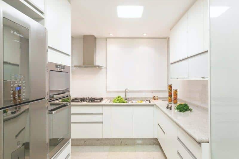 an example of a marble countertop for a kitchen with a stove and furniture, all-white matching