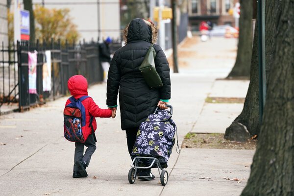 A young student being walked to P.S. 91, the Albany Avenue School in Brooklyn, earlier this month. Public school enrollment is down in New York City.