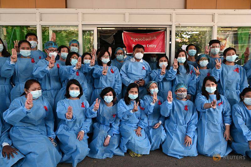 Medical staff poses during a protest against the coup that ousted elected leader Aung San Suu Kyi Y