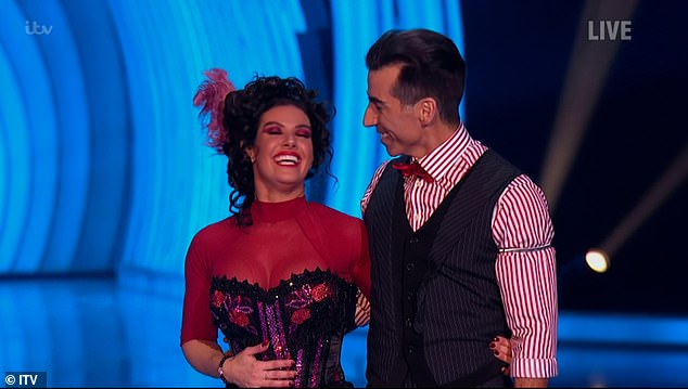 Busty! Rebekah flaunted her ample cleavage in the red and black cancan costume